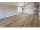 Open-concept living room with wood floors, plantation shutters, and ample natural light at 8319 E Plata Ave, Mesa, AZ 85212