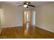 Bright living room featuring sleek, light-colored hardwood floors and a ceiling fan at 8702 N Shadow Ln, Peoria, AZ 85345