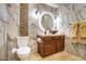 Modern bathroom with marble walls, vessel sink, a lighted mirror, and elegant fixtures at 921 E Canyon Way, Chandler, AZ 85249