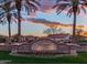 McQueen Lakes community entrance featuring mature palm trees, lush flowers, and neighborhood signage at 921 E Canyon Way, Chandler, AZ 85249