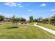 Expansive community green space with walking paths, mature trees, and manicured landscaping throughout at 921 E Canyon Way, Chandler, AZ 85249