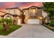 Beautiful home featuring mature landscaping, a three car garage, and stone accents on the front elevation at 921 E Canyon Way, Chandler, AZ 85249