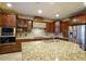 Gourmet kitchen with stainless steel appliances, custom wood cabinets, and a granite island at 921 E Canyon Way, Chandler, AZ 85249