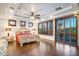 Large primary bedroom features a tray ceiling, plantation shutters, wood floors, and ensuite bath at 921 E Canyon Way, Chandler, AZ 85249