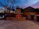 Inviting outdoor fireplace with seating and grilling area perfect for entertaining guests or relaxing after a long day at 921 E Canyon Way, Chandler, AZ 85249
