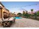 Charming backyard pool area with a dining table, string lights, and comfortable patio furniture at 921 E Canyon Way, Chandler, AZ 85249