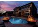 Outdoor pool with fire bowls, beautiful backyard and evening ambiance with overhead string lights at 921 E Canyon Way, Chandler, AZ 85249