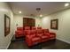 Home theater room with comfortable red seating and ambient lighting for an immersive experience at 921 E Canyon Way, Chandler, AZ 85249