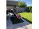 Inviting backyard with well-maintained artificial grass, patio seating, and privacy wall at 9726 E Butte St, Mesa, AZ 85207