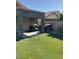 A spacious backyard featuring a covered patio, artificial turf, and a well-maintained fence at 9726 E Butte St, Mesa, AZ 85207