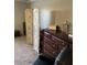 A cozy bedroom featuring a stylish dresser, decorative room divider, and comfortable chair at 9726 E Butte St, Mesa, AZ 85207