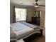A comfortable bedroom with a bed, dresser and a view out of the window at 9726 E Butte St, Mesa, AZ 85207