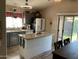 Modern kitchen with stainless steel appliances, a granite island, and ample cabinet space at 9726 E Butte St, Mesa, AZ 85207