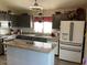 Bright kitchen featuring granite countertops, modern appliances, and ample cabinet space at 9726 E Butte St, Mesa, AZ 85207