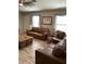 Comfortable living room with hardwood floors, plush leather seating, and bright windows at 9726 E Butte St, Mesa, AZ 85207