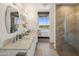Bright bathroom featuring double sinks, modern fixtures, and a view of the bedroom at 1 E Lexington Ave # 1209, Phoenix, AZ 85012