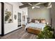 Comfortable bedroom with a large bed, accent plants, and a decorative chest at 1 E Lexington Ave # 1209, Phoenix, AZ 85012