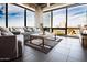 Bright living room featuring floor-to-ceiling windows with a stunning city view and comfortable seating at 1 E Lexington Ave # 1209, Phoenix, AZ 85012