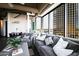 Bright living room with floor-to-ceiling windows, city views, and comfortable contemporary furnishings at 1 E Lexington Ave # 1209, Phoenix, AZ 85012