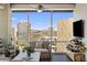 Relaxing living room with a cozy sofa, entertainment center, and a breathtaking city view at 1 E Lexington Ave # 1209, Phoenix, AZ 85012
