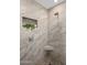 Tiled shower stall featuring a corner seat and a built-in shelving niche at 1 E Lexington Ave # 1209, Phoenix, AZ 85012