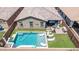 Aerial view of a private backyard featuring a pool, lounge chairs, putting green, and outdoor kitchen at 10029 E Wavelength Ave, Mesa, AZ 85212