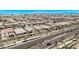 High aerial photo of neighborhood featuring many single-Gathering homes and a roadway at 10029 E Wavelength Ave, Mesa, AZ 85212