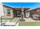 Relaxing backyard with covered patio, outdoor seating, and artificial grass at 10029 E Wavelength Ave, Mesa, AZ 85212