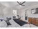 Spacious bedroom featuring a ceiling fan, a walk-in closet, and an ensuite bathroom at 10029 E Wavelength Ave, Mesa, AZ 85212