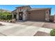 Charming single-story home featuring stone accents, a two-car garage, and desert landscaping at 10029 E Wavelength Ave, Mesa, AZ 85212