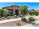 Lovely single-story house showcasing stone details, a 2-car garage, and well-kept desert landscaping at 10029 E Wavelength Ave, Mesa, AZ 85212