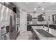 Modern kitchen with dark cabinets, stainless steel appliances, and a granite countertop island at 10029 E Wavelength Ave, Mesa, AZ 85212