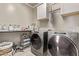 Well-equipped laundry room featuring modern washer and dryer units at 10029 E Wavelength Ave, Mesa, AZ 85212