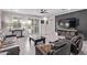 Stylish living room featuring tile floors, a ceiling fan, and an entertainment center on an accent wall at 10029 E Wavelength Ave, Mesa, AZ 85212