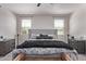 Cozy bedroom featuring a padded headboard, patterned bedding, neutral decor, and lots of light at 10029 E Wavelength Ave, Mesa, AZ 85212