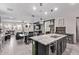 Open-concept kitchen and living area with a large island, dining table, and comfortable seating at 10029 E Wavelength Ave, Mesa, AZ 85212