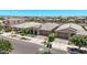 Street view of single-story homes showcasing stone details, two-car garages, and landscaped front yards at 10029 E Wavelength Ave, Mesa, AZ 85212