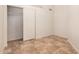 Bedroom featuring tile flooring, large closet and neutral color scheme at 10244 N 65Th Ln, Glendale, AZ 85302