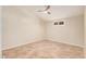 Simple bedroom with tile flooring, a ceiling fan, and natural light from the window at 10244 N 65Th Ln, Glendale, AZ 85302