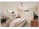 Staged bedroom featuring modern furnishings, neutral tones, and a ceiling fan at 10244 N 65Th Ln, Glendale, AZ 85302