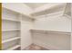 Walk-in closet featuring shelves and tile flooring at 10244 N 65Th Ln, Glendale, AZ 85302