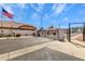 Gated community entrance with an American flag and well-maintained landscaping, ensuring security and curb appeal at 10244 N 65Th Ln, Glendale, AZ 85302