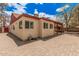 Home exterior featuring brick flooring, red accents and shuttered windows at 10244 N 65Th Ln, Glendale, AZ 85302