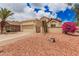 A Southwestern-style home with mature desert landscaping and an attached two-car garage at 10244 N 65Th Ln, Glendale, AZ 85302