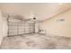 Spacious garage featuring concrete flooring and a roll up door at 10244 N 65Th Ln, Glendale, AZ 85302