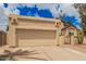 Two car garage of a beige stucco home with a private, gated courtyard at 10244 N 65Th Ln, Glendale, AZ 85302