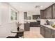Staged kitchen featuring modern appliances, gray cabinets, and a small table at 10244 N 65Th Ln, Glendale, AZ 85302