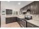 Kitchen featuring dark cabinets, stainless steel appliances, and light countertops at 10244 N 65Th Ln, Glendale, AZ 85302