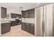 Bright kitchen with gray cabinets, stainless steel refrigerator, and ample counter space at 10244 N 65Th Ln, Glendale, AZ 85302