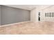 Bright living room with tile flooring, gray accent wall, and white trim at 10244 N 65Th Ln, Glendale, AZ 85302